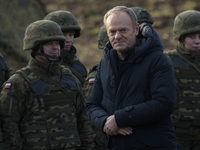 Polish Prime Minister Donald Tusk visits members of the Polish armed forces at the Polish-Russian border in Dabrowka, Poland, on November 30...