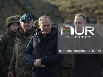 Polish Prime Minister Donald Tusk (left) and Deputy Minister of National Defense Cezary Tomczyk (right) talk before a press conference in Da...