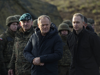 Polish Prime Minister Donald Tusk (left) and Deputy Minister of National Defense Cezary Tomczyk (right) talk before a press conference in Da...