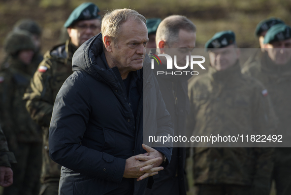 Polish Prime Minister Donald Tusk visits members of the Polish armed forces at the Polish-Russian border in Dabrowka, Poland, on November 30...