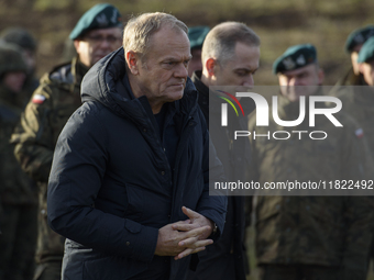 Polish Prime Minister Donald Tusk visits members of the Polish armed forces at the Polish-Russian border in Dabrowka, Poland, on November 30...