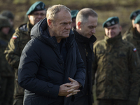 Polish Prime Minister Donald Tusk visits members of the Polish armed forces at the Polish-Russian border in Dabrowka, Poland, on November 30...