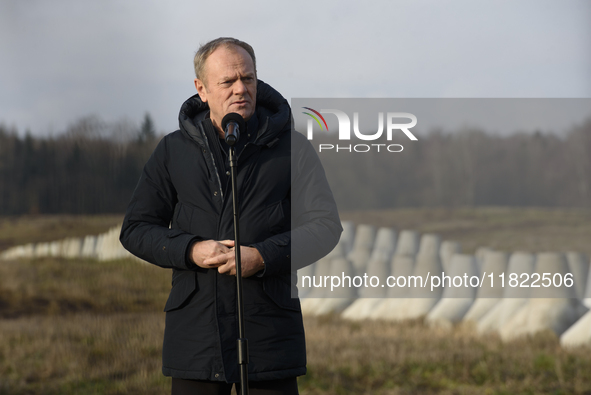 Polish Prime Minister Donald Tusk speaks to the media at the Polish-Russian border in Dabrowka, Poland, on November 30, 2024. The East Shiel...