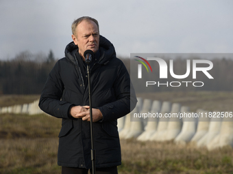 Polish Prime Minister Donald Tusk speaks to the media at the Polish-Russian border in Dabrowka, Poland, on November 30, 2024. The East Shiel...