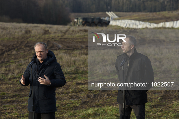 Polish Prime Minister Donald Tusk (left) and Deputy Minister of National Defense Cezary Tomczyk (right) take part in a press conference at t...