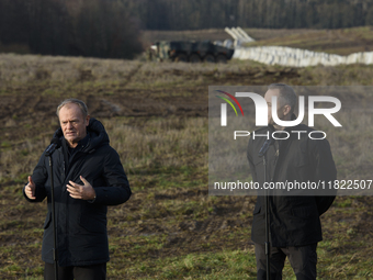 Polish Prime Minister Donald Tusk (left) and Deputy Minister of National Defense Cezary Tomczyk (right) take part in a press conference at t...