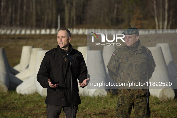 Deputy Minister of National Defense Cezary Tomczyk (left) and Col. Tomasz Sawczuk (right) take part in a press conference in Dabrowka, Polan...