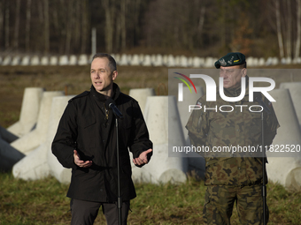 Deputy Minister of National Defense Cezary Tomczyk (left) and Col. Tomasz Sawczuk (right) take part in a press conference in Dabrowka, Polan...