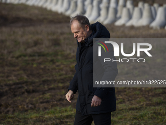 Polish Prime Minister Donald Tusk leaves a press conference held at the Polish-Russian border in Dabrowka, Poland, on November 30, 2024. The...