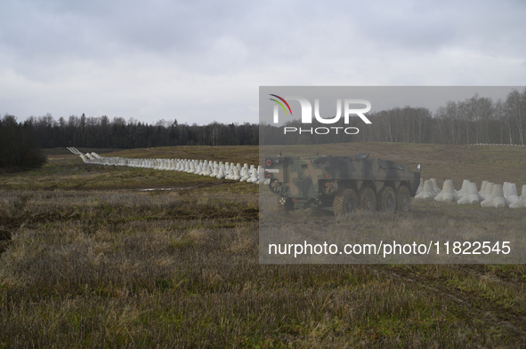 Anti-tank concrete fortifications are pictured at the Polish-Russian border as members of the Polish armed forces stand guard in Dabrowka, P...