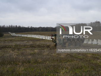 Anti-tank concrete fortifications are pictured at the Polish-Russian border as members of the Polish armed forces stand guard in Dabrowka, P...