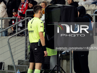 Referee Damian Kos checks the VAR screen during a game between KS Cracovia and Zaglebie Lubin in Krakow, Poland, on November 29, 2024. The m...