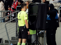 Referee Damian Kos checks the VAR screen during a game between KS Cracovia and Zaglebie Lubin in Krakow, Poland, on November 29, 2024. The m...