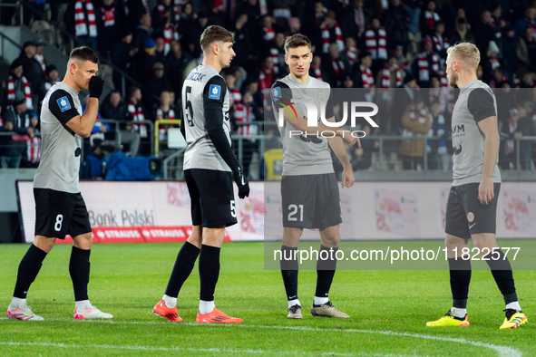 Zaglebie players Damian Dabrowski, Aleks Lawniczak, and Tomasz Pienko participate in the game between KS Cracovia and Zaglebie Lubin in Krak...