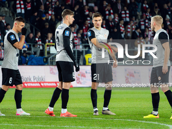 Zaglebie players Damian Dabrowski, Aleks Lawniczak, and Tomasz Pienko participate in the game between KS Cracovia and Zaglebie Lubin in Krak...