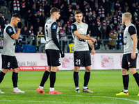 Zaglebie players Damian Dabrowski, Aleks Lawniczak, and Tomasz Pienko participate in the game between KS Cracovia and Zaglebie Lubin in Krak...