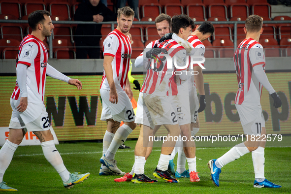 Cracovia players Jakub Jugas, Fabian Bzdyl, and Benjamin Kallman celebrate scoring a goal during the game between KS Cracovia and Zaglebie L...