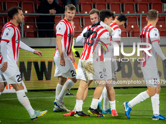 Cracovia players Jakub Jugas, Fabian Bzdyl, and Benjamin Kallman celebrate scoring a goal during the game between KS Cracovia and Zaglebie L...