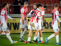 Cracovia players Jakub Jugas, Fabian Bzdyl, and Benjamin Kallman celebrate scoring a goal during the game between KS Cracovia and Zaglebie L...