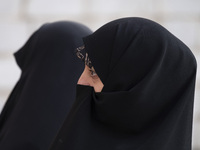 Two veiled Iranian women participate in a funeral in northwestern Tehran, Iran, on November 30, 2024. (