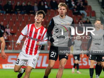 Fabian Bzdyl and Bartlomiej Kludka participate in the game between KS Cracovia and Zaglebie Lubin in Krakow, Poland, on November 29, 2024. T...