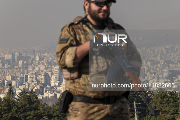 An armed IRGC special force military personnel monitors an area during a funeral for General Kioumars Pourhashemi, a commander of the Islami...