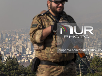 An armed IRGC special force military personnel monitors an area during a funeral for General Kioumars Pourhashemi, a commander of the Islami...