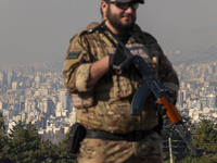 An armed IRGC special force military personnel monitors an area during a funeral for General Kioumars Pourhashemi, a commander of the Islami...