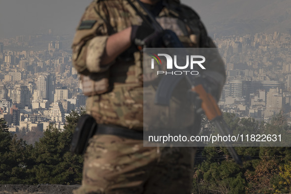 An armed IRGC special force military personnel monitors an area during a funeral for General Kioumars Pourhashemi, a commander of the Islami...