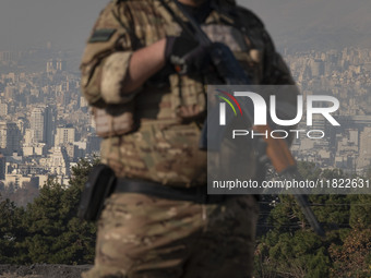 An armed IRGC special force military personnel monitors an area during a funeral for General Kioumars Pourhashemi, a commander of the Islami...