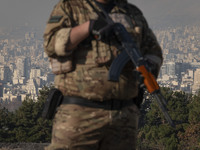 An armed IRGC special force military personnel monitors an area during a funeral for General Kioumars Pourhashemi, a commander of the Islami...