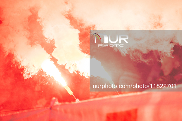 Cracovia fans attend the game between KS Cracovia and Zaglebie Lubin in Krakow, Poland, on November 29, 2024. Team supporters burn smoke fla...