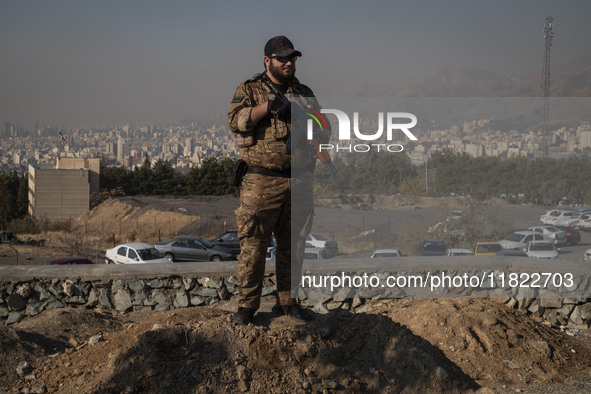 An armed IRGC special force military personnel monitors an area during a funeral for General Kioumars Pourhashemi, a commander of the Islami...