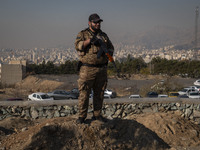 An armed IRGC special force military personnel monitors an area during a funeral for General Kioumars Pourhashemi, a commander of the Islami...