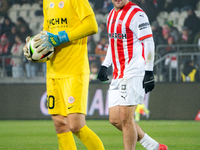 Benjamin Kallman and Zaglebie goalkeeper Dominik Hladun participate in the game between KS Cracovia and Zaglebie Lubin in Krakow, Poland, on...