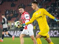 Benjamin Kallman and Zaglebie goalkeeper Dominik Hladun participate in the game between KS Cracovia and Zaglebie Lubin in Krakow, Poland, on...