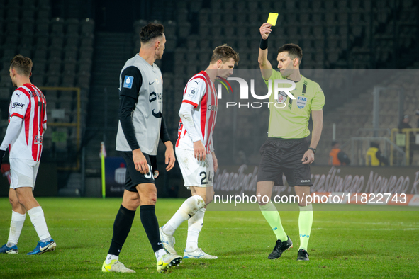 Referee Damian Kos shows a yellow card to Jakub Jugas during the game between KS Cracovia and Zaglebie Lubin in Krakow, Poland, on November...