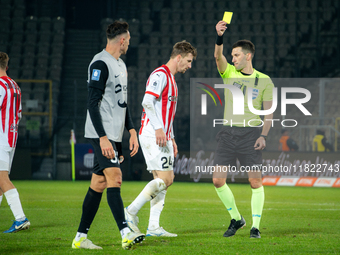 Referee Damian Kos shows a yellow card to Jakub Jugas during the game between KS Cracovia and Zaglebie Lubin in Krakow, Poland, on November...