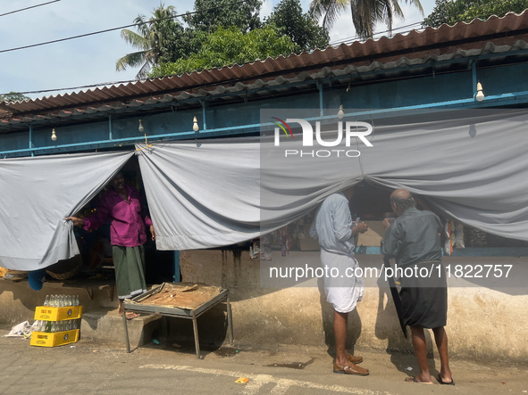 Shops hang cloth sheets to protect from the strong sun and intense heat in Konni, Pathanamthitta, Kerala, India, on April 5, 2024. 