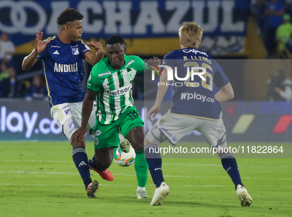 Andres Llinas and Marino Hinestroza of Millonarios fight for the ball during the match on the 3rd date of the semifinal quadrangulars of gro...