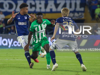 Andres Llinas and Marino Hinestroza of Millonarios fight for the ball during the match on the 3rd date of the semifinal quadrangulars of gro...