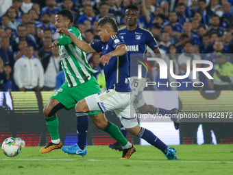 Jorge Arias of Millonarios F.C. and Edwin Cardona of Atletico Nacional fight for the ball during the match on the 3rd date of the semifinal...