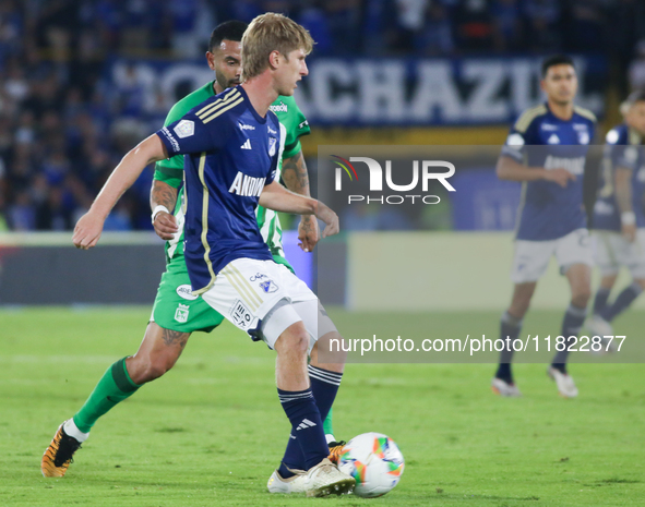 Andres Llinas of Millonarios F.C. and Edwin Cardona of Atletico Nacional fight for the ball during the match on the 3rd date of the semifina...