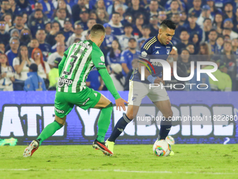 Radamel Falcao Garcia of Millonarios and Felipe Aguirre of Atletico Nacional fight for the ball during the match on the third date of the se...