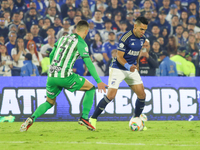 Radamel Falcao Garcia of Millonarios and Felipe Aguirre of Atletico Nacional fight for the ball during the match on the third date of the se...