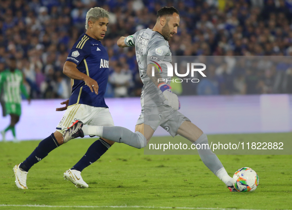 Daniel Catano of Millonarios and David Ospina of Atletico Nacional fight for the ball during the match on the 3rd date of the semifinal quad...