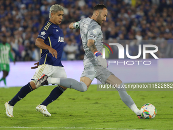 Daniel Catano of Millonarios and David Ospina of Atletico Nacional fight for the ball during the match on the 3rd date of the semifinal quad...