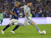 Daniel Catano of Millonarios and David Ospina of Atletico Nacional fight for the ball during the match on the 3rd date of the semifinal quad...