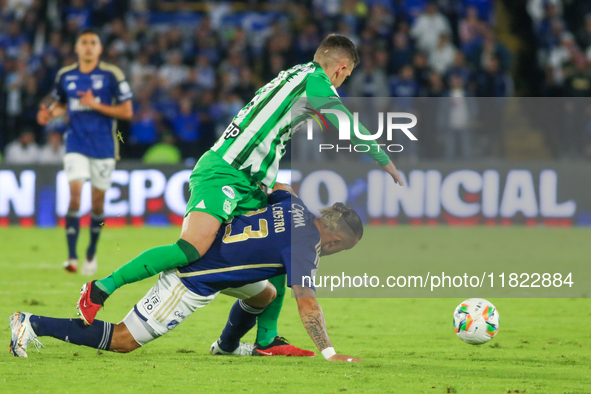 Leonardo Castro of Millonarios and Felipe Aguirre of Atletico Nacional fight for the ball during the match on the third date of the semifina...