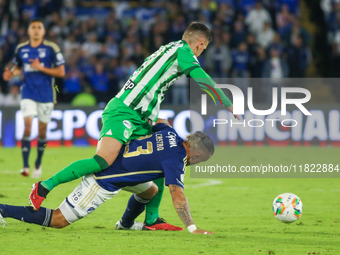 Leonardo Castro of Millonarios and Felipe Aguirre of Atletico Nacional fight for the ball during the match on the third date of the semifina...